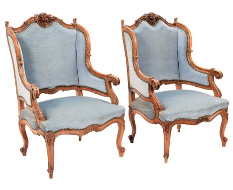 A Pair of Late 19th Century Continental Walnut Framed Armchairs, recovered in close-nailed light green velvet, the moulded fr
