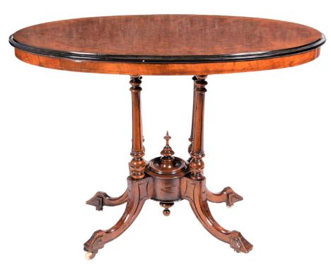 A Victorian Burr Walnut and Ebonised Centre Table, circa 1870, of oval form, on spindle and fluted supports with moulded base