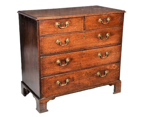 A George III Oak Straight Front Chest of Drawers, late 18th century, the moulded top above two short and three long graduated