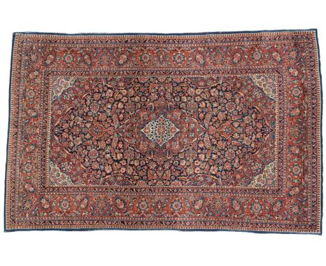 Pair of Kashan RugsCentral Iran, circa 1930Each with an indigo field of floral vines around a madder and ivory medallion fram