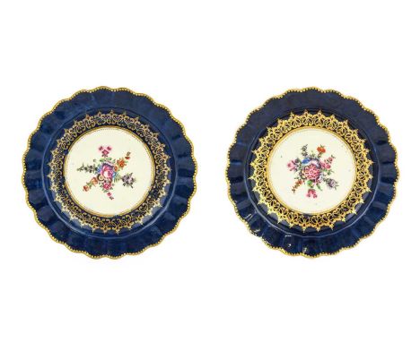 A Pair of Worcester Porcelain Dessert Plates, circa 1770, painted with sprays of flowers on a blue ground gilt with scrolls a