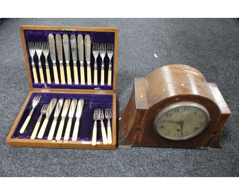 A walnut cased Art Deco mantel clock (a/f), together with an Edwardian oak canteen of fish cutlery 