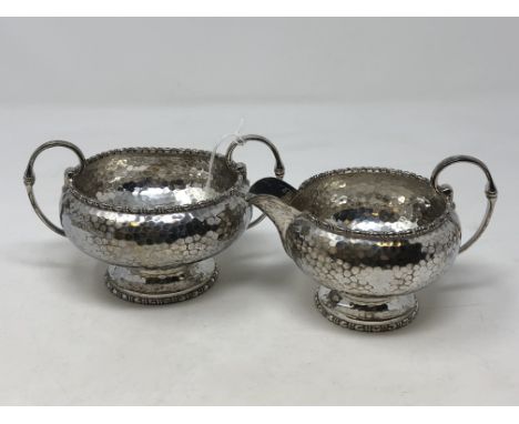 A hammered-silver cream jug and matching sugar basin, Walker &amp; Hall CONDITION REPORT: 348.6g. 