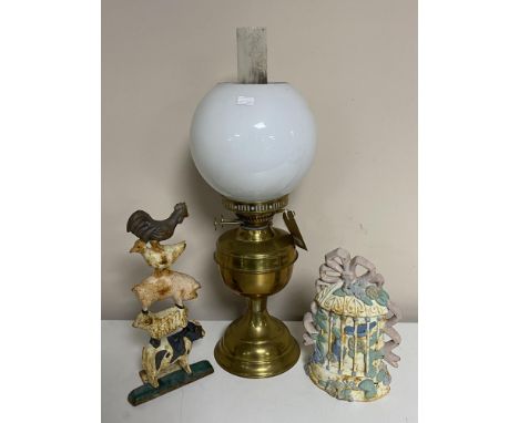 A brass Duplex oil lamp with chimney and shade together with two cast iron door stops 