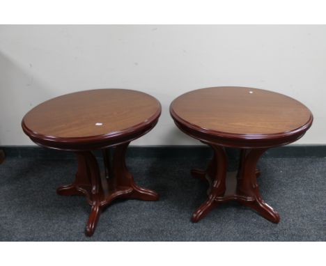 A pair of reproduction pedestal lamp tables. 