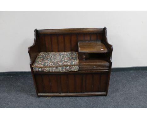 An oak telephone seat with tapestry cushion 