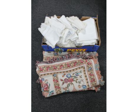 A box of a quantity of embroidered table linen and two fringed tapestry throws 