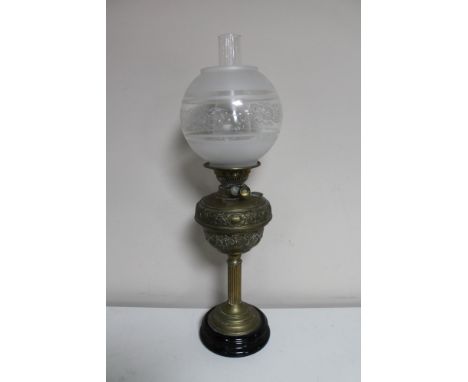 A brass oil lamp with etched glass shade 