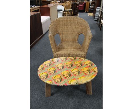 An oversized wicker armchair and a teak coffee table with Marilyn Monroe themed top 