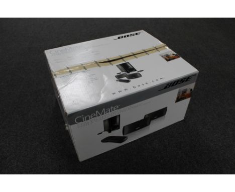 A boxed Bose Cinemate digital home theatre speaker system with remote 