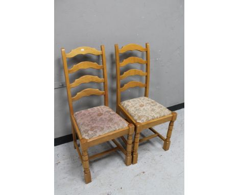 A pair of ladder backed dining chairs. 
