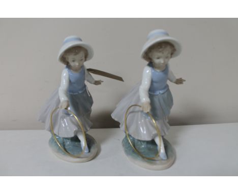 Two Nao figures of girls with hoops