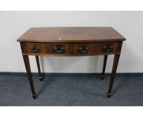 A 20th century mahogany bow-fronted console table. 