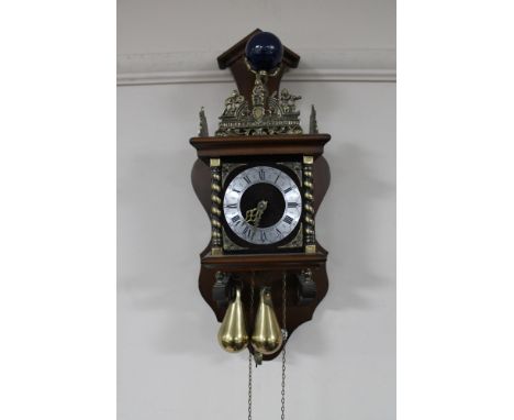 A continental wall clock with brass pear drop weights 
