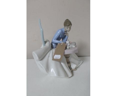 A large Nao figure, girl seated with kitten 