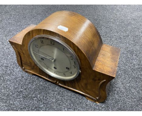 A 1930's walnut cased continental mantel clock with pendulum and key 