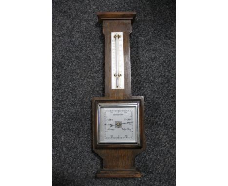 An oak barometer/thermometer with square silvered dial 