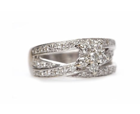 EIGHTEEN CARAT WHITE GOLD DIAMOND RINGthe broad openwork band formed by three sections of diamond set white gold with a centr