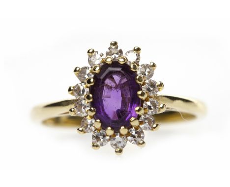 EIGHTEEN CARAT GOLD AMETHYST AND DIAMOND CLUSTER RINGthe central oval amethyst 7mm long and surrounded by round diamonds, siz