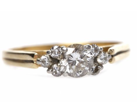 EIGHTEEN CARAT GOLD DIAMOND RINGset with a central round brilliant cut diamond of approximately 0.34 carats flanked by two gr