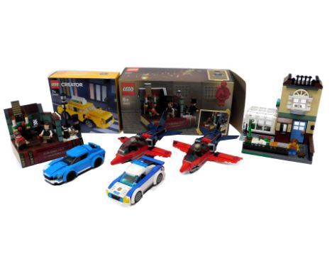 Various built Lego kits, comprising police cars, Speed Champion car, two Red Arrows planes, Christmas carol book scene, model