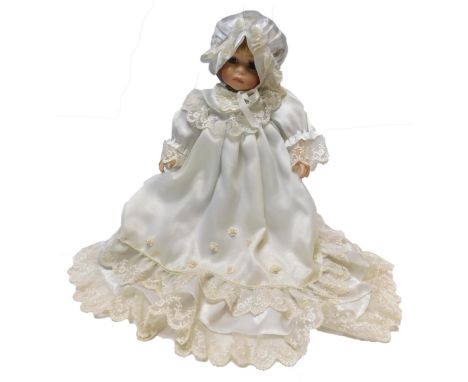 A Knightsbridge Collection ceramic headed doll, with a lying baby, boxed.