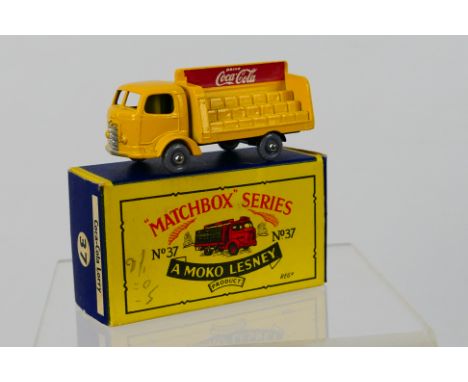 Matchbox - A boxed Karrier Bantam Coca Cola lorry with black base and grey plastic wheels.# 37. The model appears Mint in a V