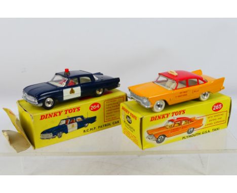 Dinky - A pair of diecast Dinky vehicles to include #264 R.C.M.P Patrol Car and #265 Plymouth U.S.A Taxi. Items show signs of