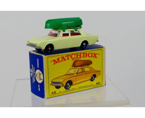 Matchbox - A boxed Ford Corsair in cream with green roof rack and boat # 45. The model appears in Mint condition in an Excell