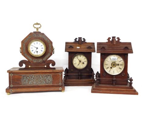 Mahogany two train alarm mantel clock striking on a bell, the 4.75" silvered dial with central alarm dial, within a gabled fe