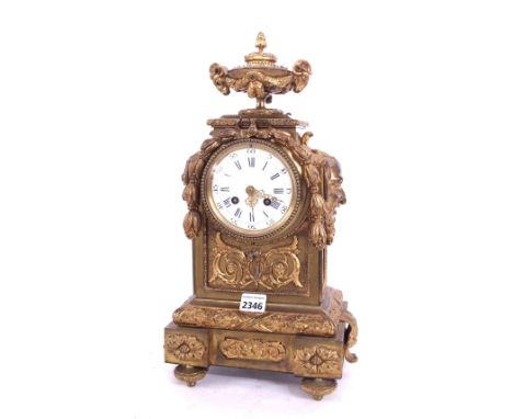 Gilt metal two train mantel clock striking on a bell, the 4" dial within an ornate stepped case, 17" high (pendulum)