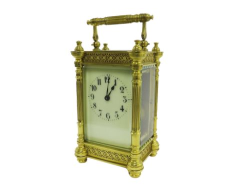 Carriage clock timepiece, the cream dial within an ornate pillared brass case, 6.25" high