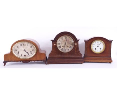 Walnut three train mantel clock, the movement striking on five rods, the 6.5" silvered oval dial within a rounded arched case
