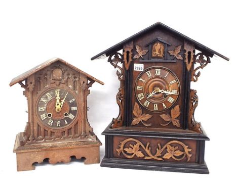 Walnut and ebonised Black Forest two train cuckoo clock, the 5.5" dial within a gabled stepped case with applied foliate carv