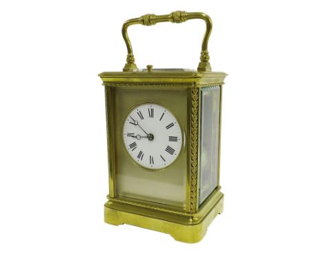 French repeater carriage clock striking on a gong, the 2.25" circular dial within a silvered mask and ornate corniche brass c