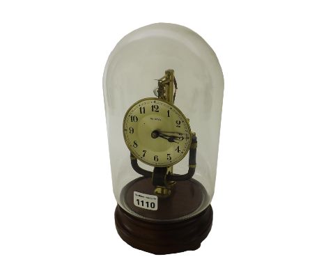 Bulle type 800 days electric mantel clock, the 3.5" silvered dial under a heavy glass dome and upon a stepped turned mahogany