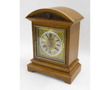 German oak two train mantel clock striking on a gong, the 7" square dial with silvered chapter ring, within a stepped case su