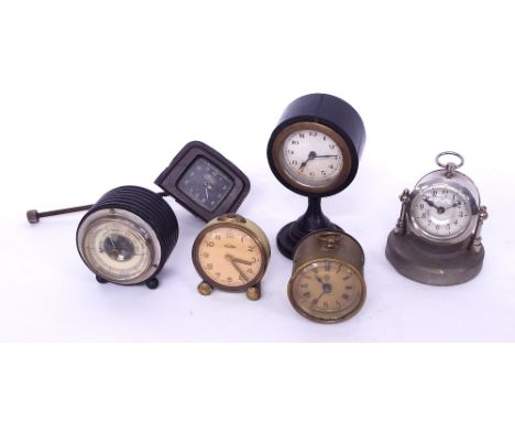 Ford brown Bakelite car clock; together with four other small clock timepieces and a small aneroid barometer within an ebonis