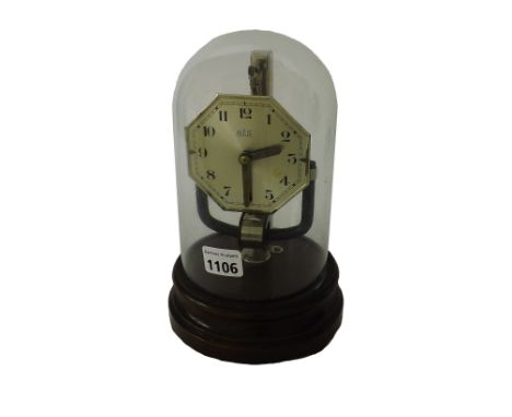 Bulle electric mantel clock, the 3.5" octagonal silvered dial under a glass dome and upon a stepped circular oak base, 10.5" 