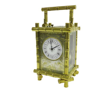 Good brass repeater carriage clock striking on a gong, the 2" circular dial within a silvered gilt highlighted mask decorated