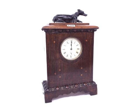 Rosewood inlaid mantel clock alarm timepiece, the 3.5" dial within a stepped case surmounted by a seated greyhound, 14.5" 