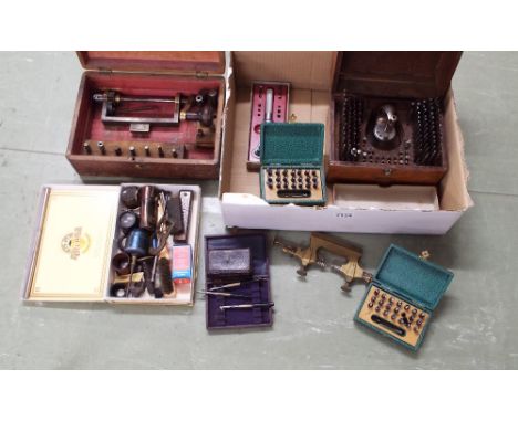 Precision tools including a cased Helios staking set, an old mainspring winder with associated accessories, box, an old Jacot
