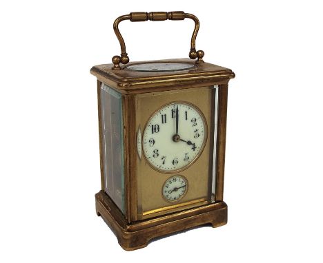 French brass alarm carriage clock striking on a bell, the circular off-white dial with Arabic numerals over the alarm dial wi