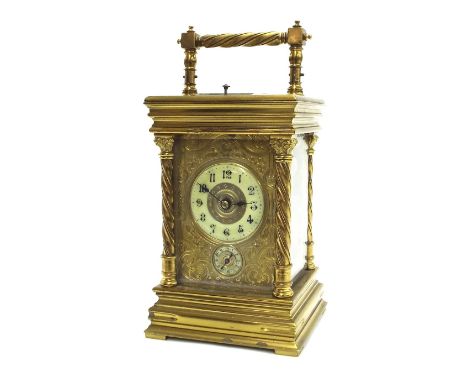 Brass repeater carriage clock striking on a gong, the 2" chapter ring above a subsidiary alarm dial within an engraved gilt m