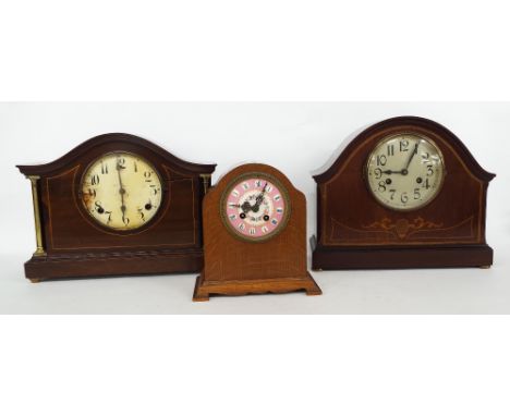 Oak two train mantel clock striking on a bell, with 3.5" pink enamel dial within an arched stepped case, 8.5" high; together 