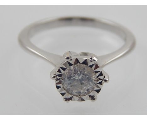 An 18 carat white gold solitaire diamond ring, set round cut stone of 0.64 carats.