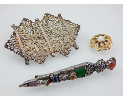 A yellow metal opal and sapphire circular pierced brooch together with a Scottish hardstone cloak brooch and a whiote metal b