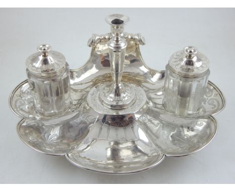 A Victorian silver scallop shell standish, the anthemion engraved stand housing a central taper stick and a pair of lidded gl