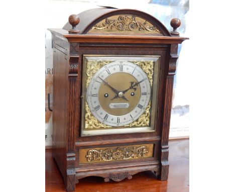 A late Victorian oak mantel clock, eight day movement, quarter repeating, striking on two gongs, the silvered chapter ring wi