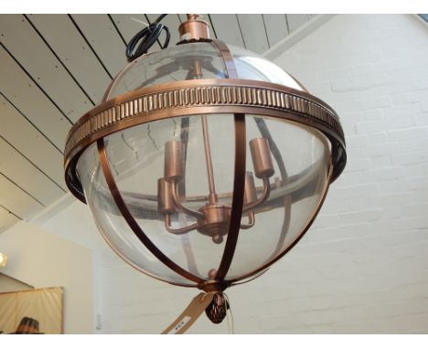 A modern copper spherical glass hall lantern, with pineapple finial. 